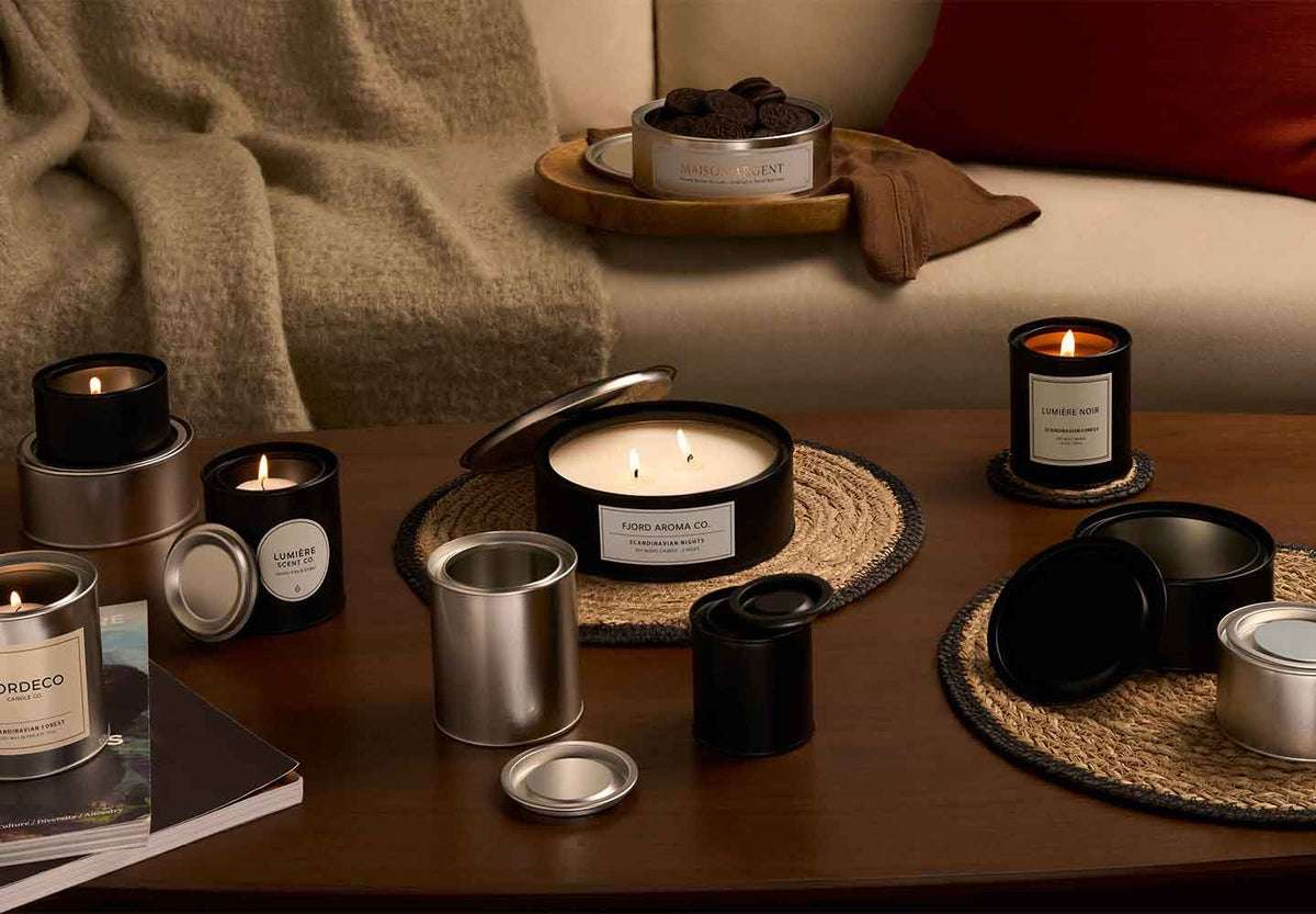 Lever lid Candle tins in a living room with biscuits and candles. 